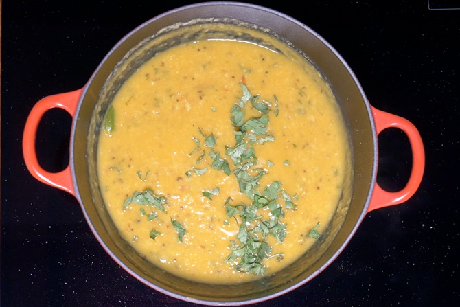 adding coriander leaves to make dal fry