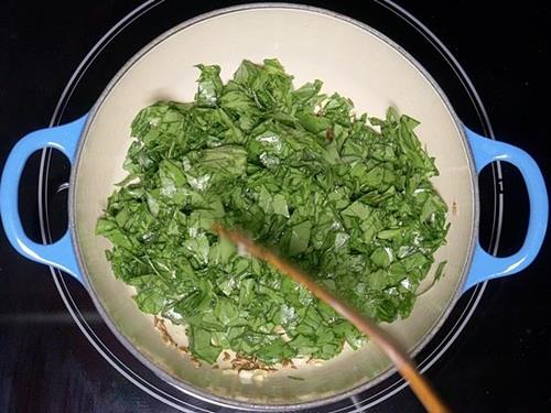 frying palak to make spinach dal