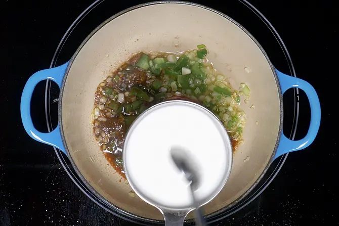 stirring corn flour to make manchurian