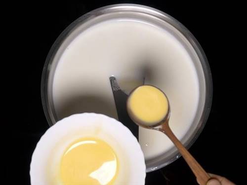 pour custard milk in batches to make fruit custard recipe