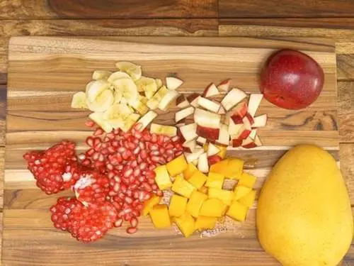chop chilled fruits to make fruit custard recipe 