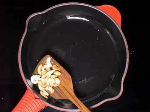 toasting cashews to make bread upma