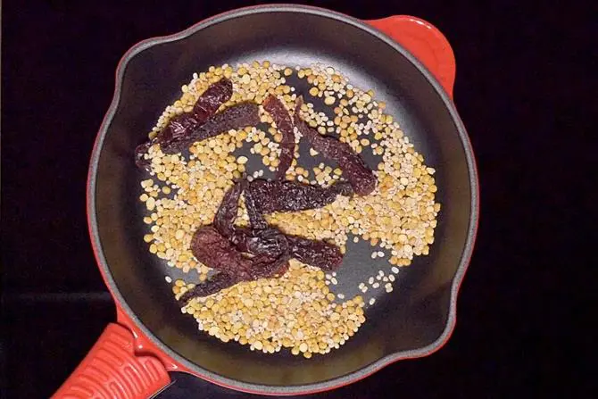 dry roasting lentils chilies to make sambar powder