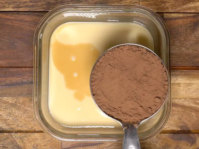 adding cocoa powder to condensed milk for chocolate ice cream
