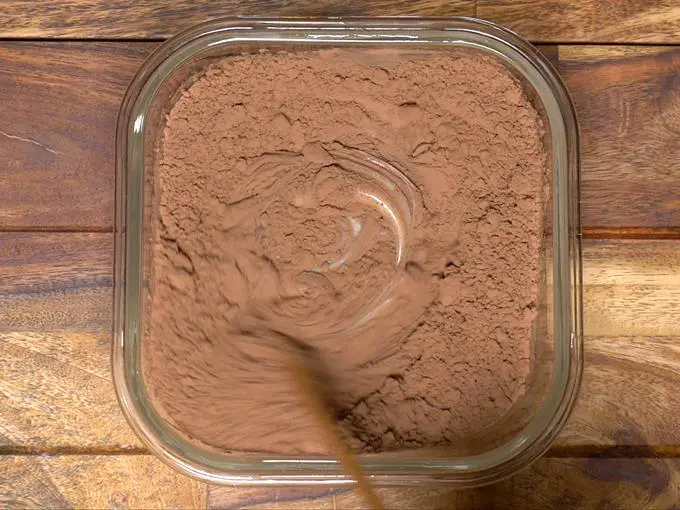 mixing cocoa with condensed milk