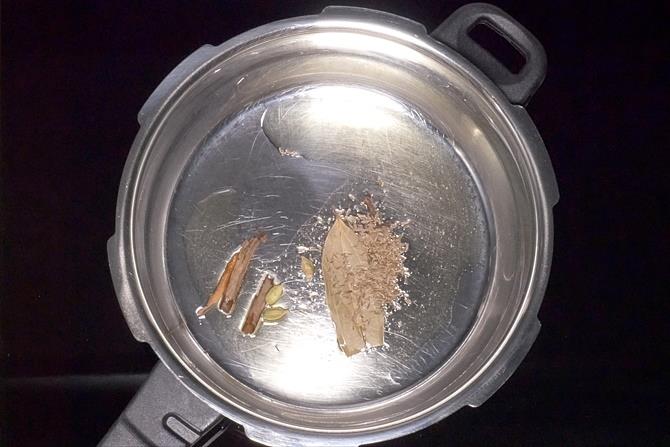 frying spices to make corn pulao