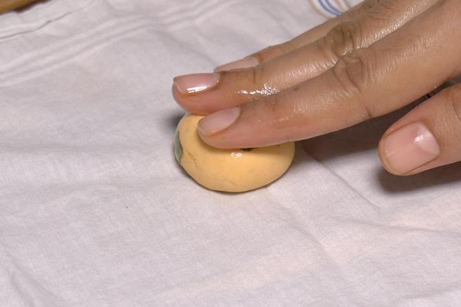 make thattai by flattening the dough ball