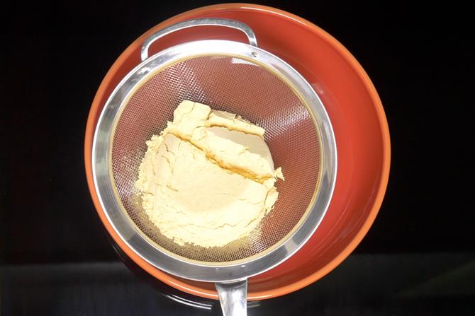 sieving besan 2 times to make mysore pak