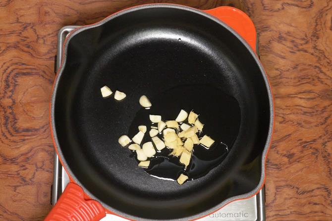 frying ginger garlic in oil to make kadai mushroom recipe