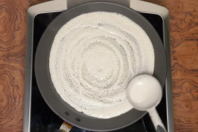 Spread millet batter to make dosa