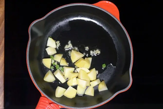 adding boiled cubed potatoes to make aloo chaat recipe
