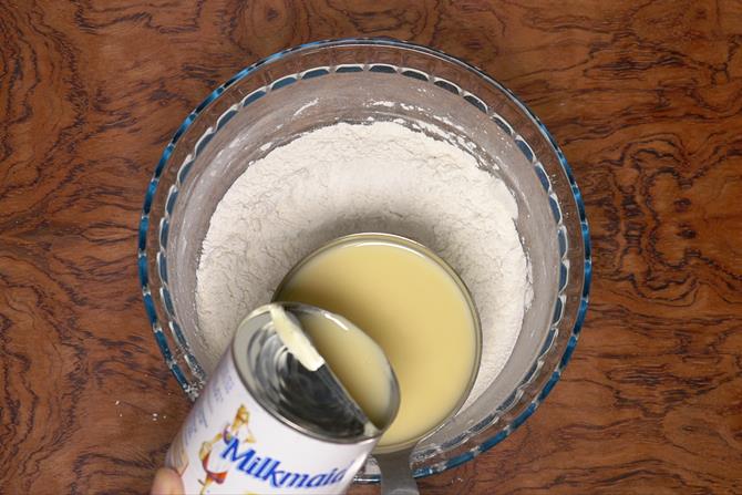 Pouring condensed milk to make eggless vanilla cake