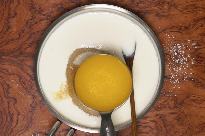 Pour melted butter to make eggless tutti frutti cake