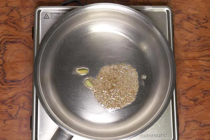 frying spices in oil to make paneer do pyaza