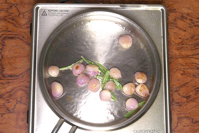 frying onions green chilies to make paneer do pyaza