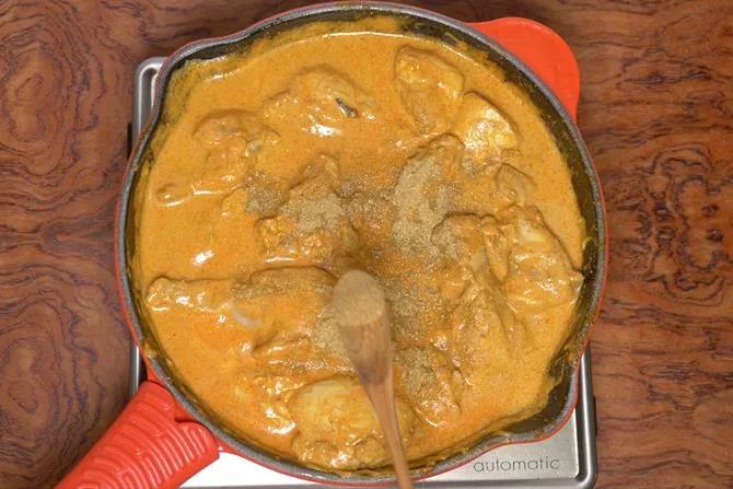 adding spice powders to make chicken korma