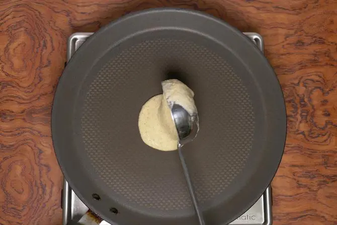 pouring mixed dal dosa batter