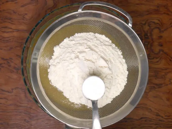 sieving flour, soda, baking powder to make cooker cake recipe