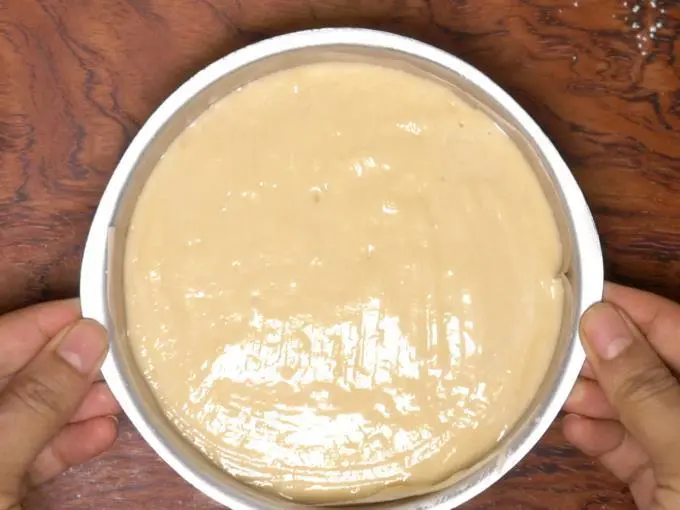 pouring cake batter to pan