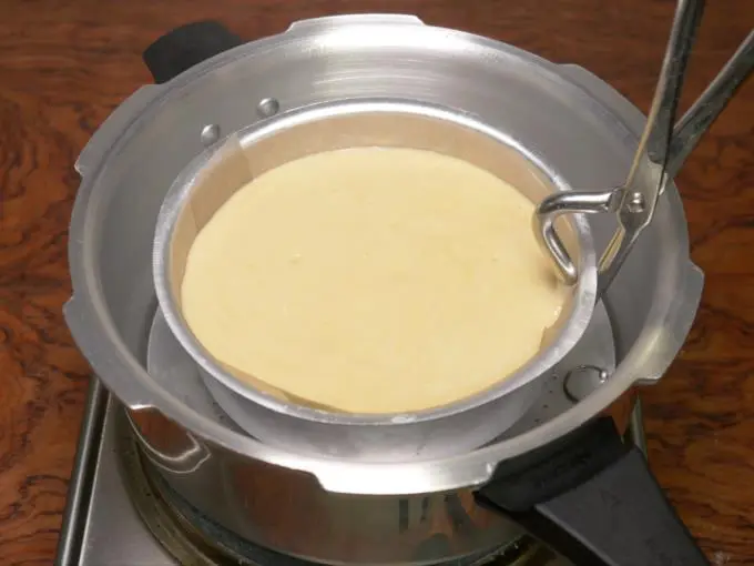 placing the cake pan in cooker