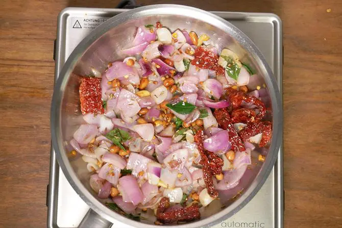 adding curry leaves to make onion chutney