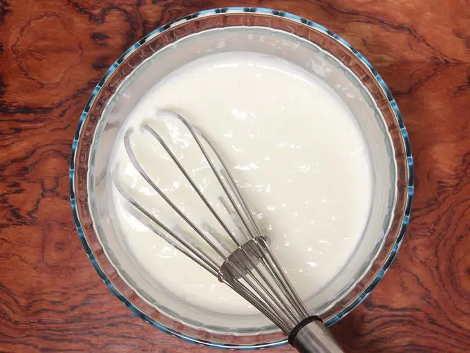 whisking curd to make salt lassi