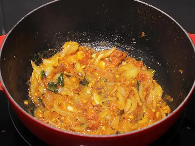 Frying onion tomato masala to make poori masala