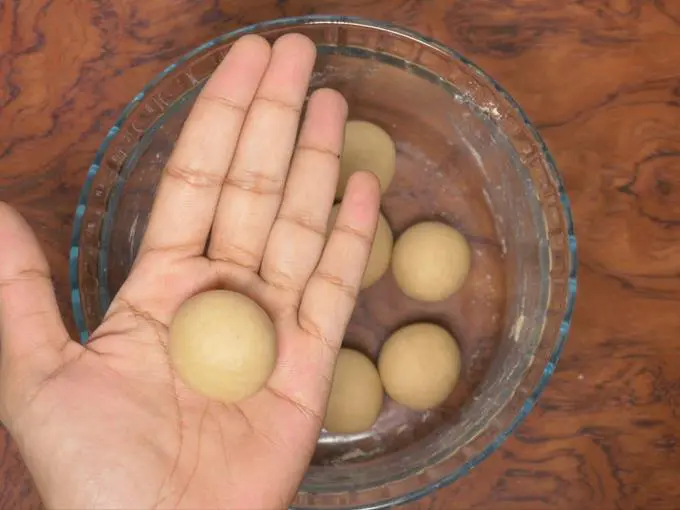 smoothen the balls to make poori