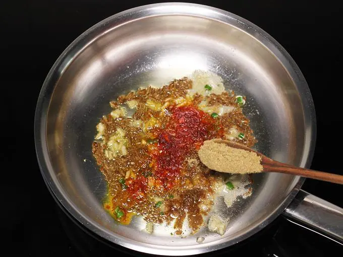 adding coriander powder to make jeera aloo