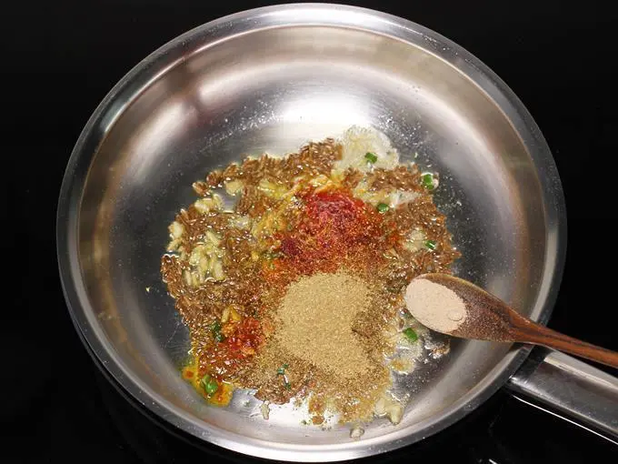 adding salt to make jeera aloo