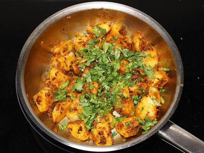 sprinkle coriander leaves to make jeera aloo