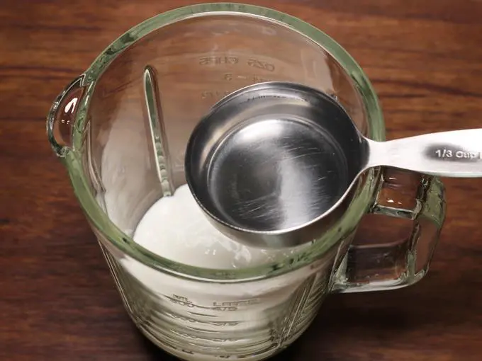 pouring water to make lassi