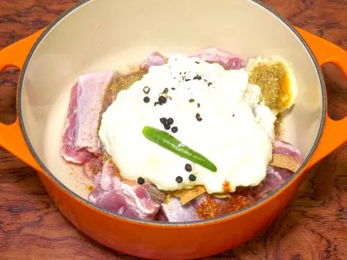 yogurt being added to mutton