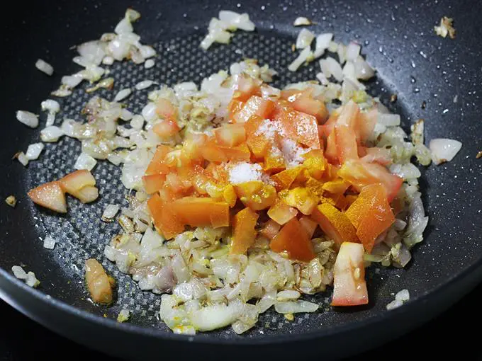 adding chopped tomatoes