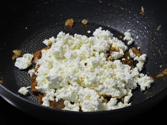 adding crumbled paneer