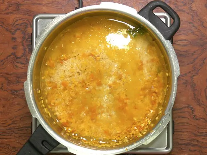 pouring water to make khichdi