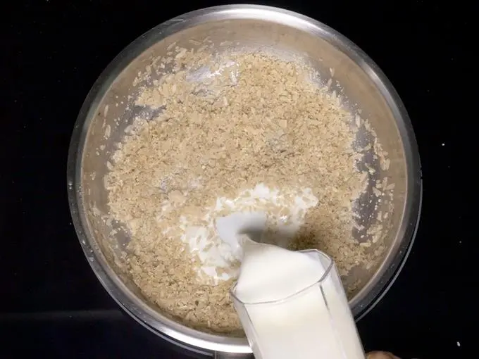 pouring milk to make aval payasam