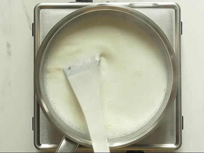stirring milk to make lauki ka halwa