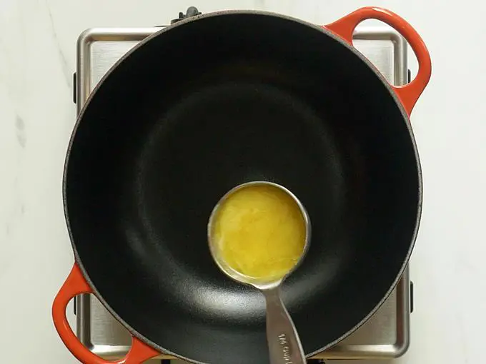 pouring ghee to pan to make lauki halwa