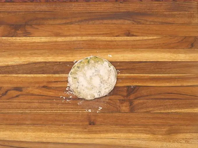 sprinkling wheat flour on thepla dough