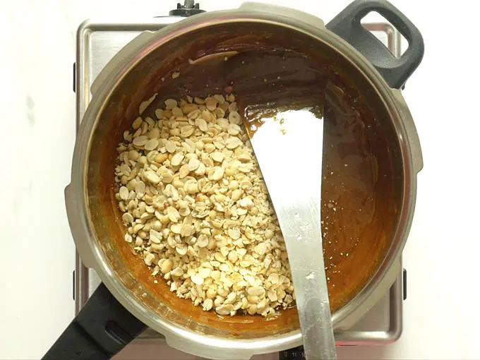 mix peanuts with jaggery syrup to make chikki recipe