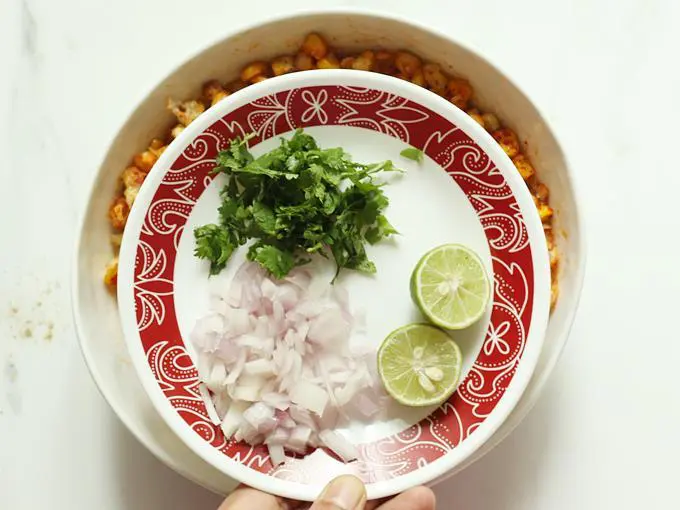 adding onions, coriander leaves and lemon