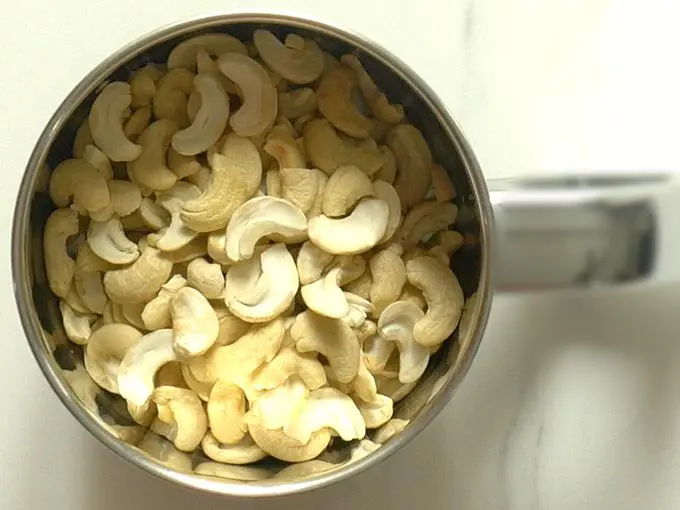 adding cashews to blender to make kaju katli recipe