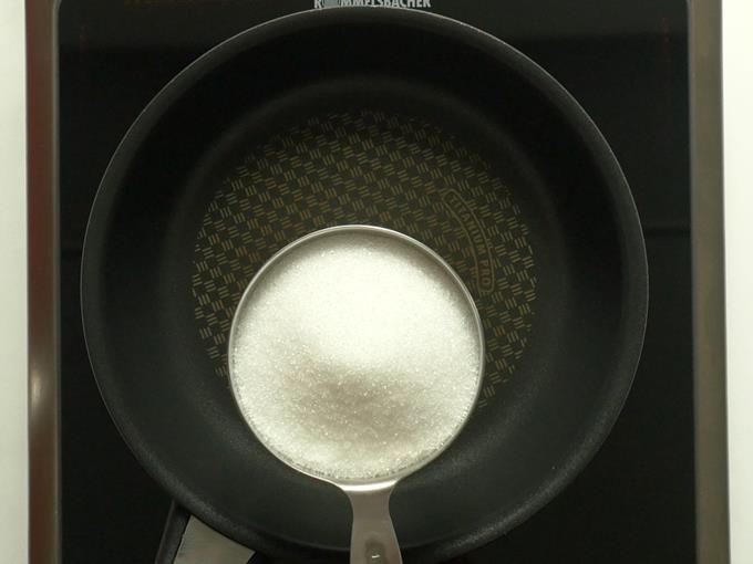 adding sugar to pan to make kaju katli recipe