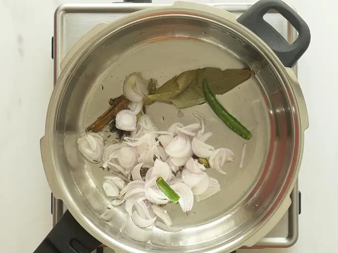 frying onions ginger to make mushroom biryani