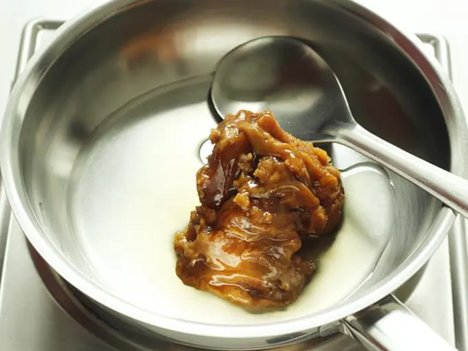 Add grated jaggery and water to a pan