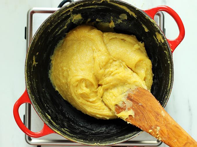 Continue to cook until besan ka halwa begins to leave the pan and becomes a mass