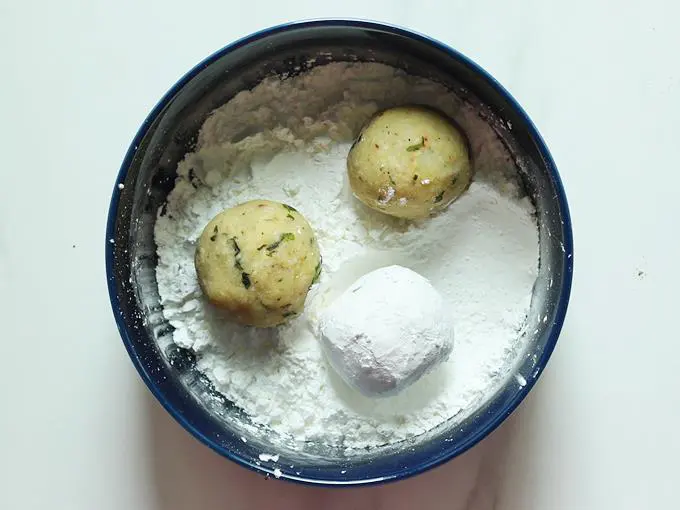 rolling cheese balls in corn flour