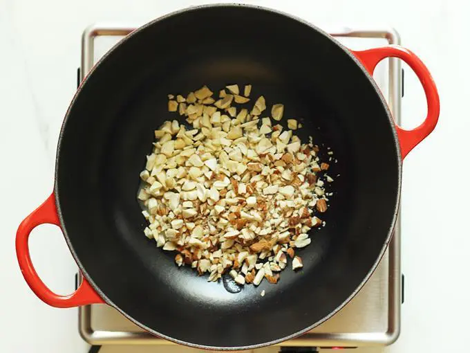 frying nuts in ghee to make gond ke laddu