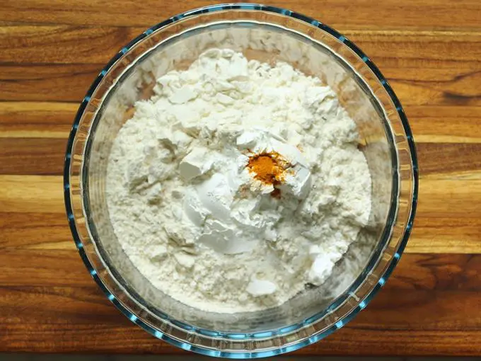 adding dry ingredients for jalebi batter